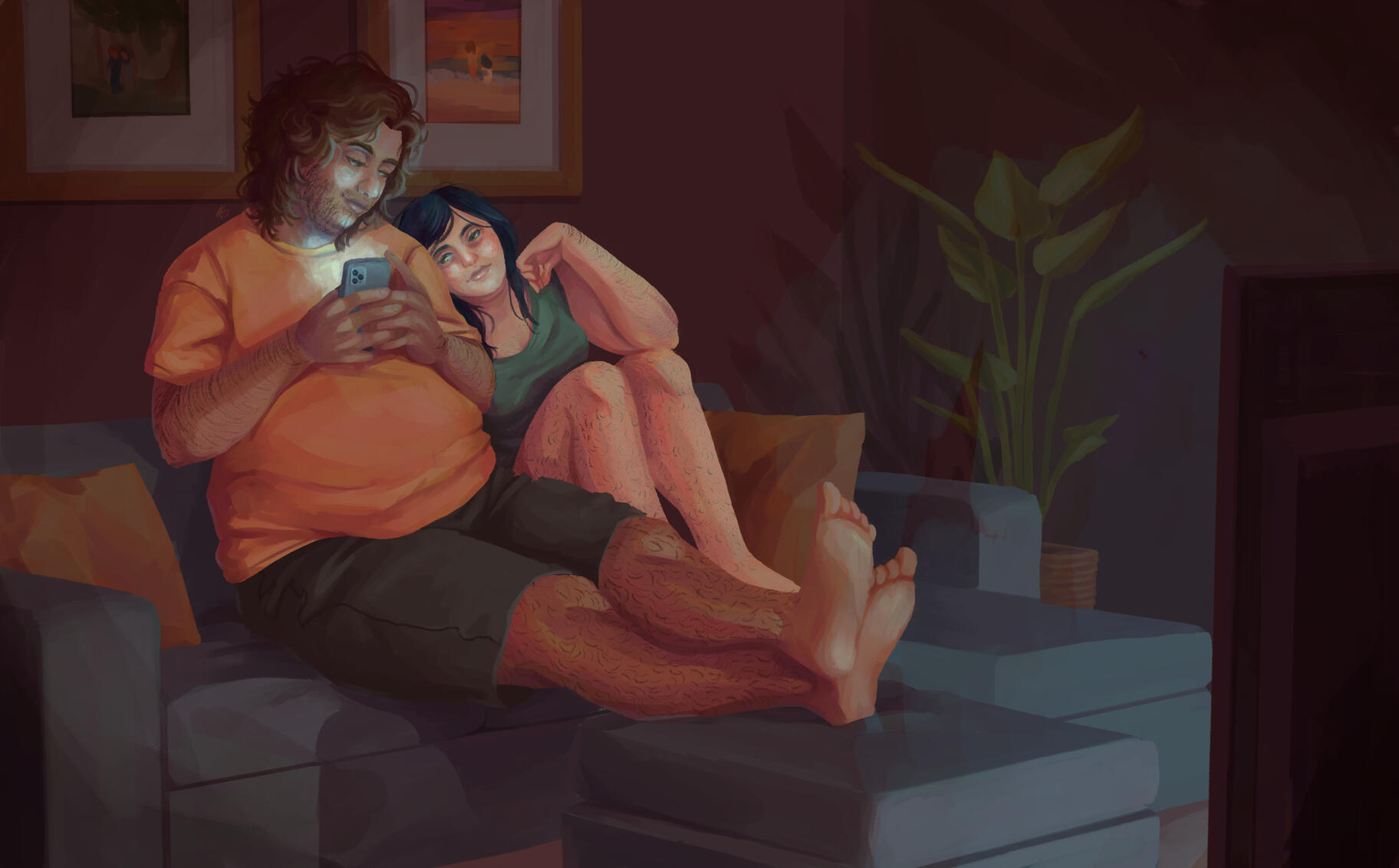 Two men sit in a dark living room watching TV. One has long Black hair and pale skin, and the other has short auburn hair and light brown skin. The red-haired man is holding his phone in both hands and looking down at the black-haired man, who is affection