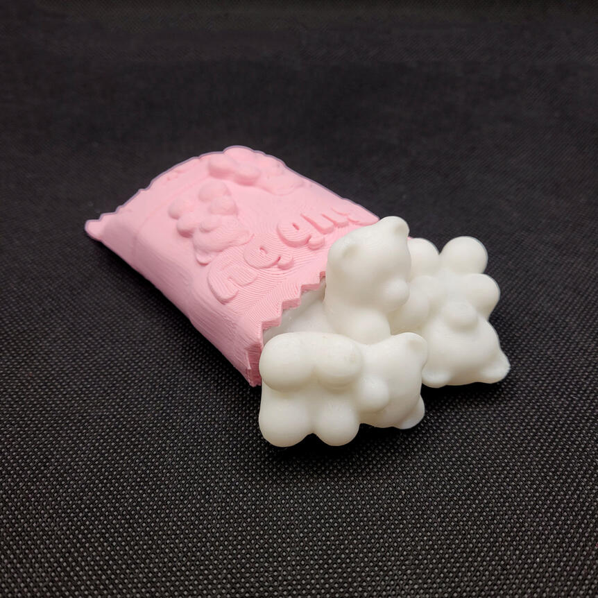 Small 3D printed light made to look like a spilled bag of gummy bears. The light is turned off.