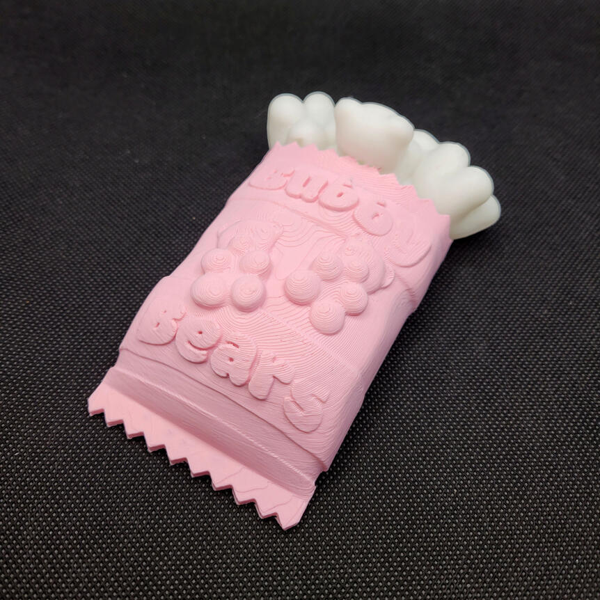 Small 3D printed light made to look like a spilled bag of gummy bears. The light is turned off.